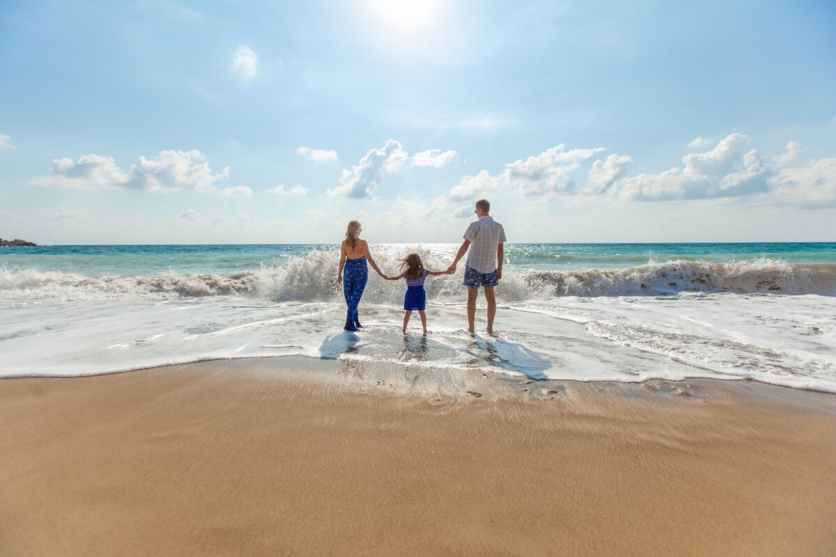 Young Family on the beach benefitting from term life insurance