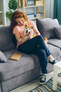 Woman cuddling with dog in her Tampa Condo